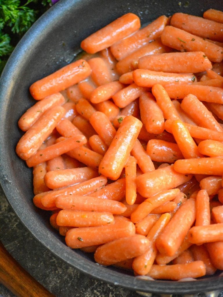 ranch glazed carrots shown in a large black skillet