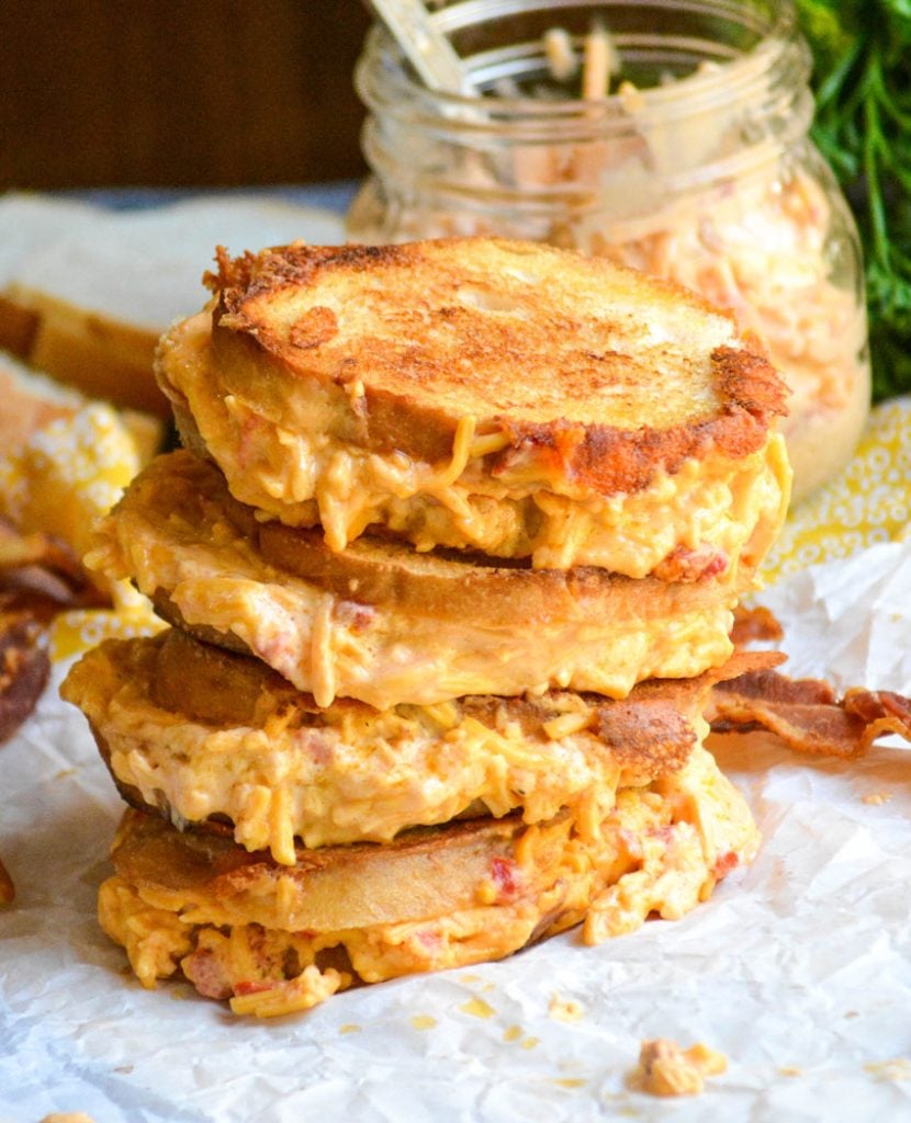 four pimento cheese grilled cheese sandwiches stacked on top of each other 