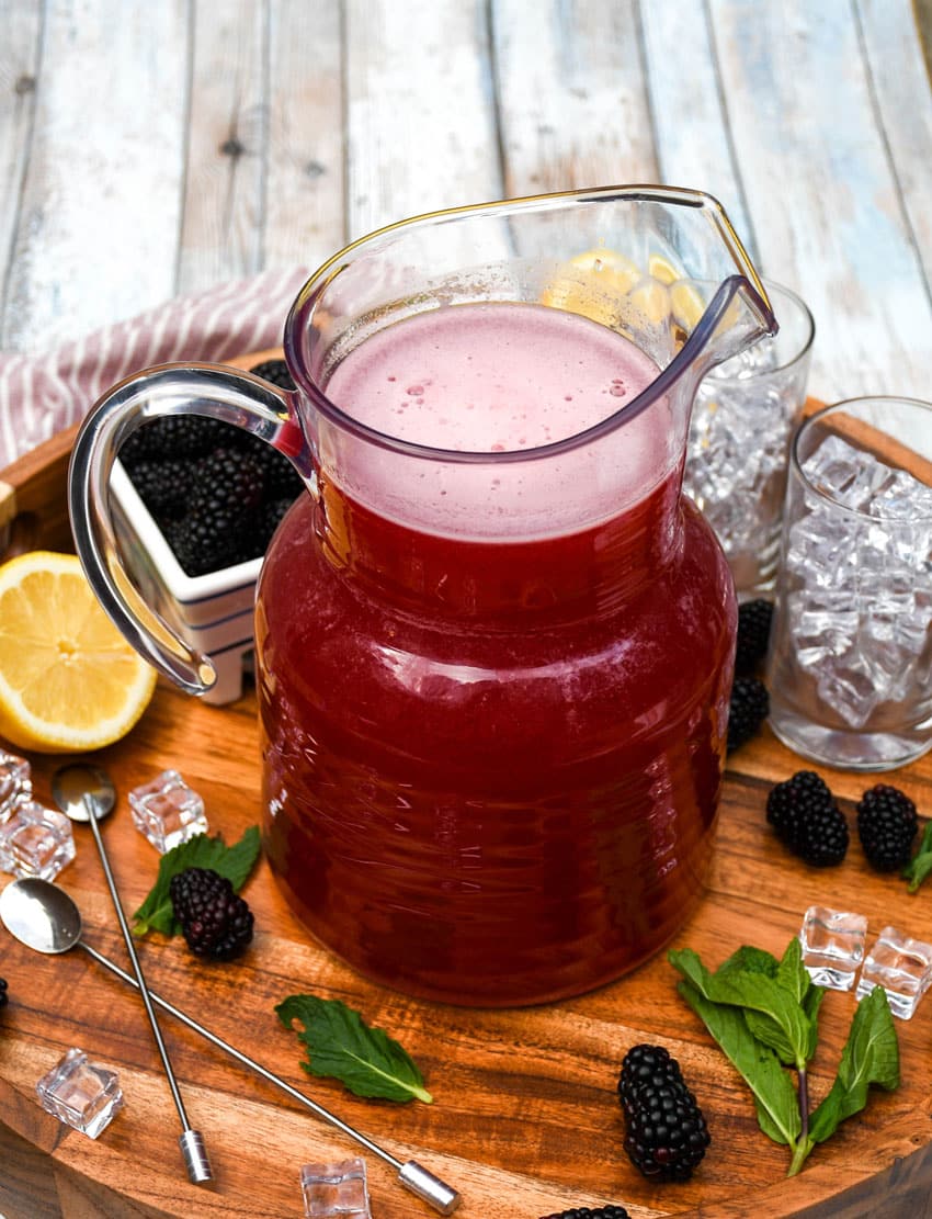 blackberry lemonade in a glass pitcher