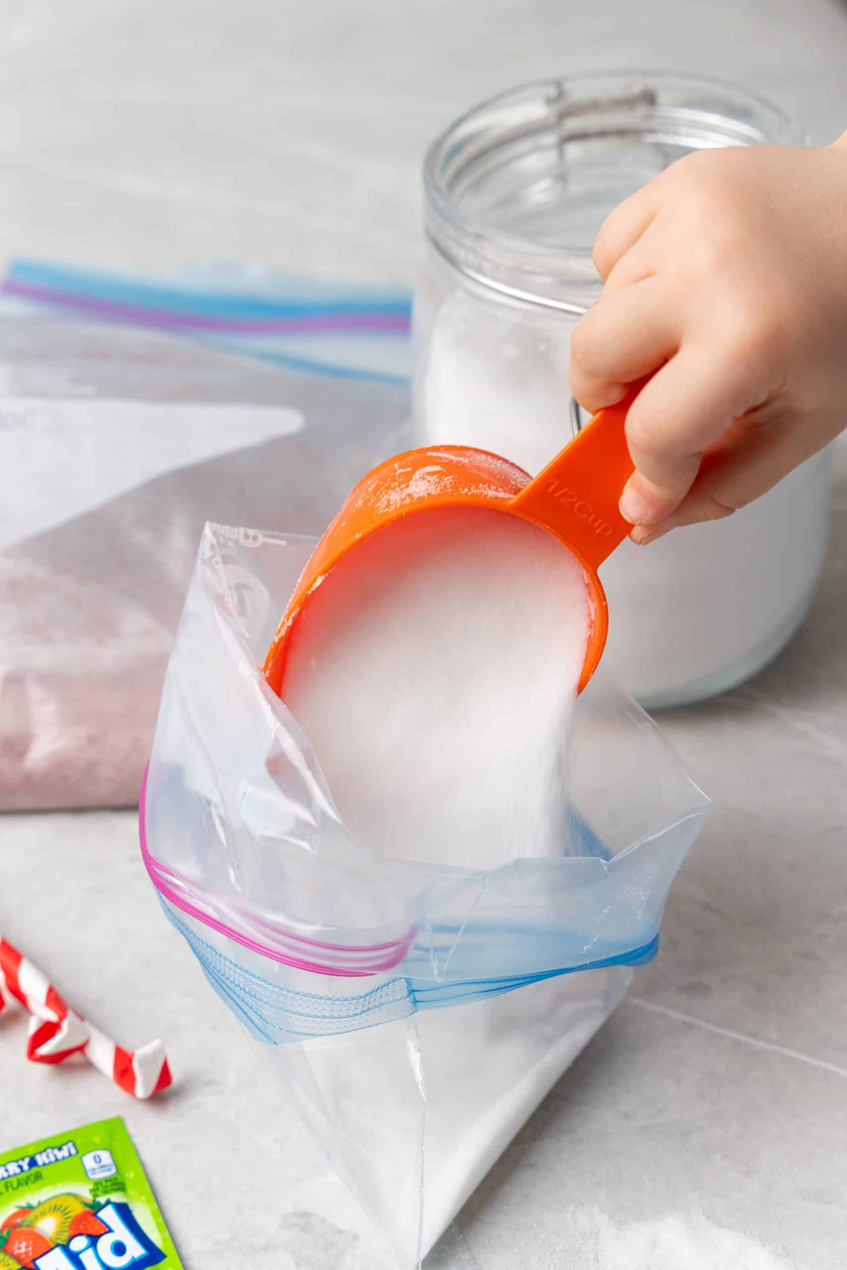 granulated sugar being poured into a ziplocking bag