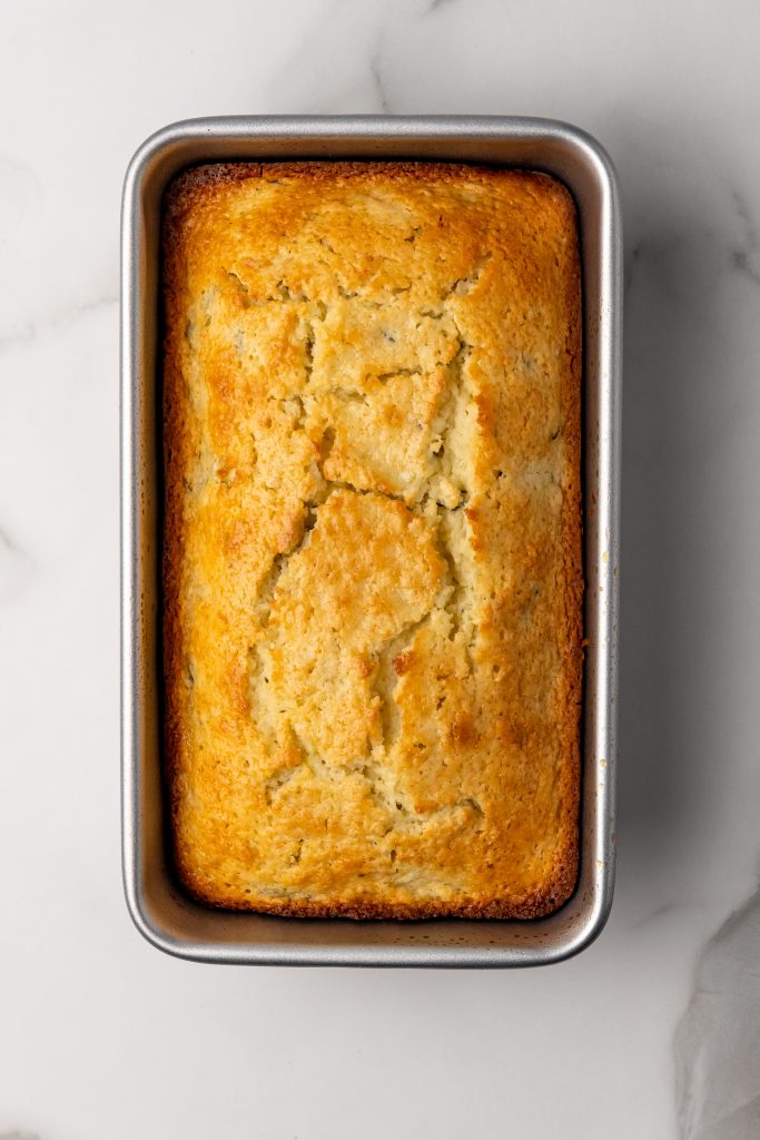 cooked lemon zucchini bread in a metal loaf pan