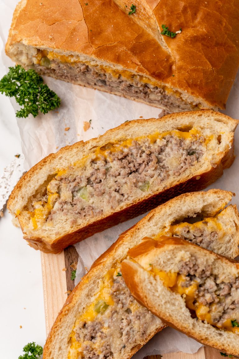 stuffed french bread sandwich slices on a wooden cutting board