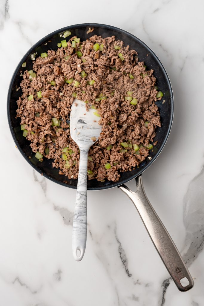 ground beef and vegetables in a black skillet