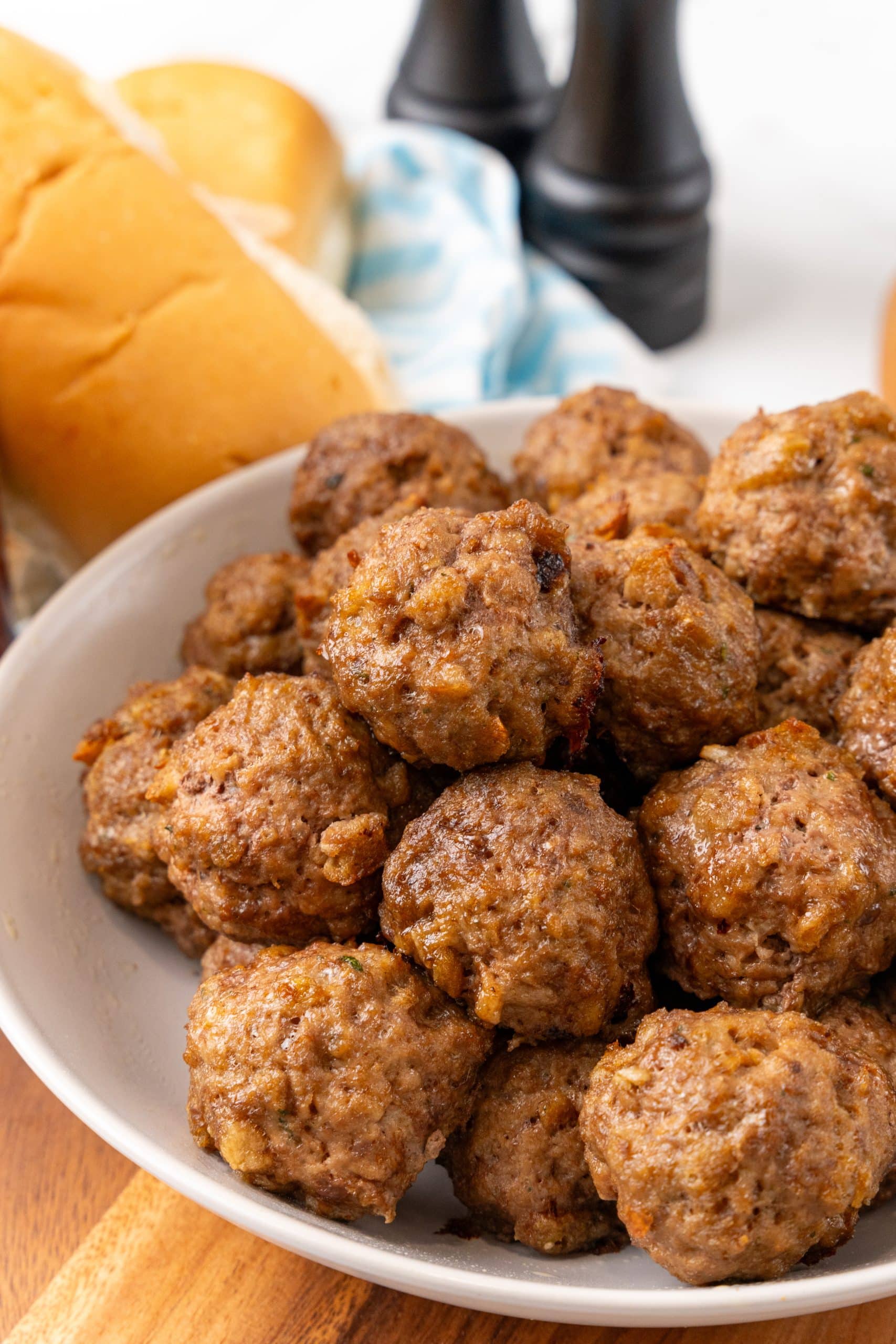 easy baked meatballs stacked in a white bowl