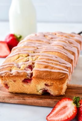 glazed strawberry bread served on a wooden cutting board