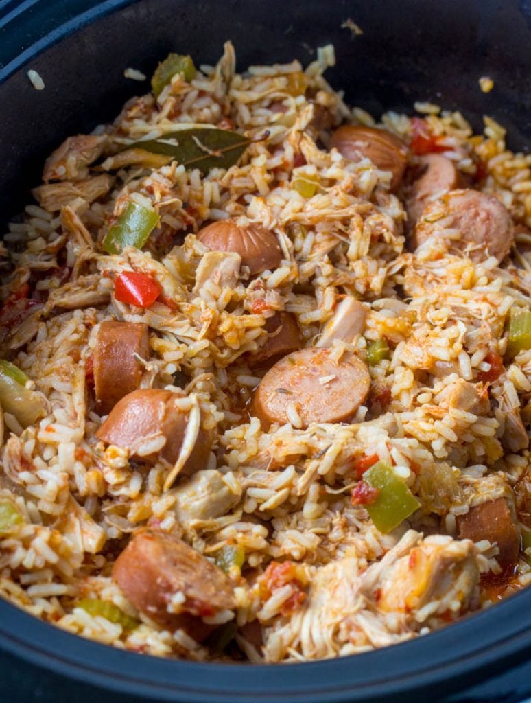 Crockpot Chicken, Sausage, & Rice shown in the black crock of a slow cooker