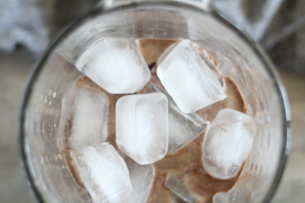 ice and hot chocolate mix shown in a blender