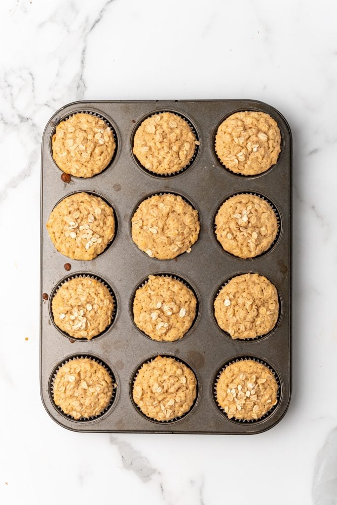 baked applesauce oatmeal muffins in a muffin tin