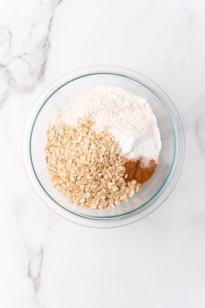 dry oatmeal muffin ingredients in a glass mixing bowl