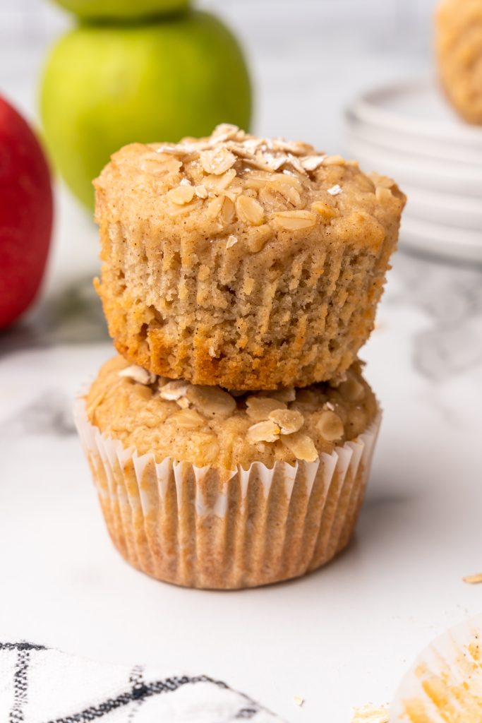 two applesauce oatmeal muffins stacked on top of each other