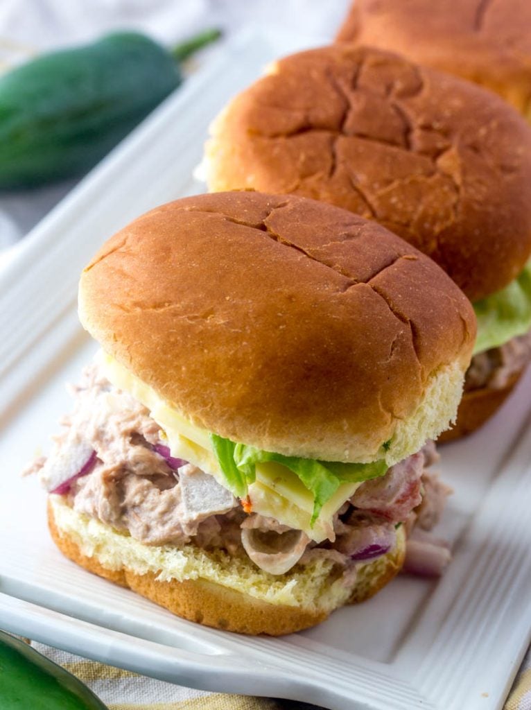 Quick & Easy Tuna Salad Sandwich Sliders shown on a narrow white rectangular serving platter