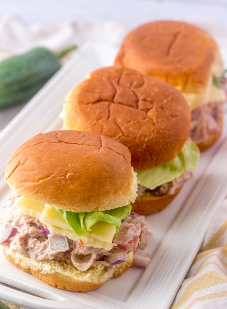 Quick & Easy Tuna Salad Sliders shown on a narrow white rectangular serving platter