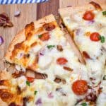 garlic chicken bacon ranch pizza on a wooden pizza peel