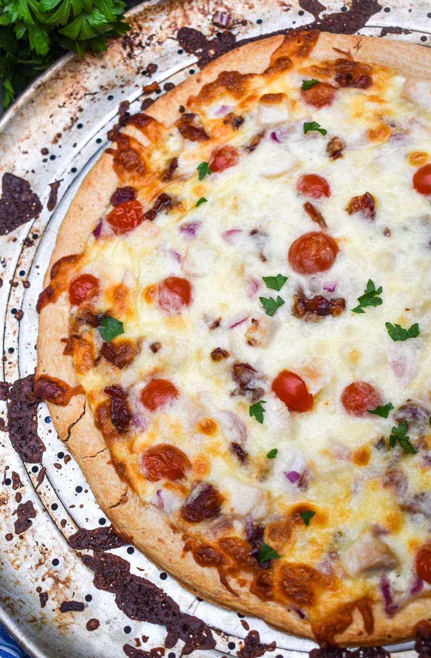 garlic chicken bacon ranch pizza on a metal pizza pan