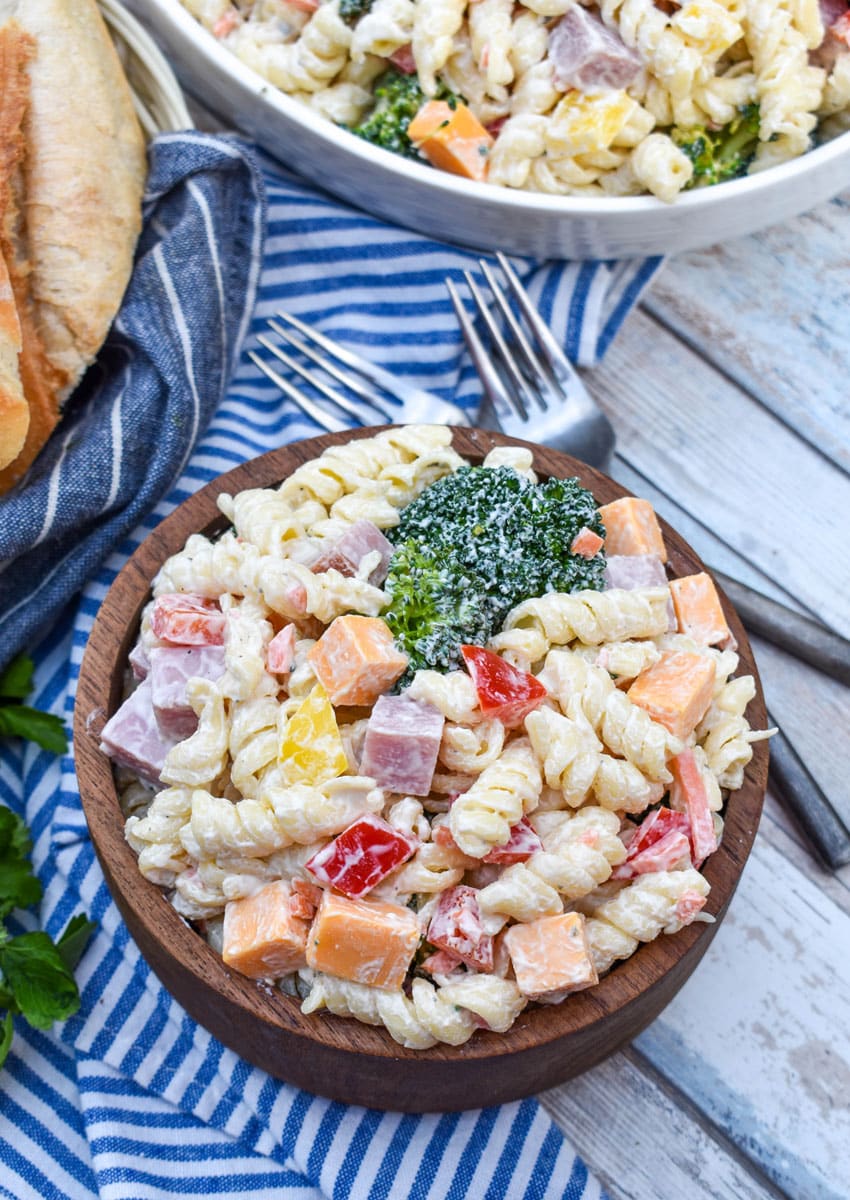 creamy ranch pasta salad in a small wooden bowl