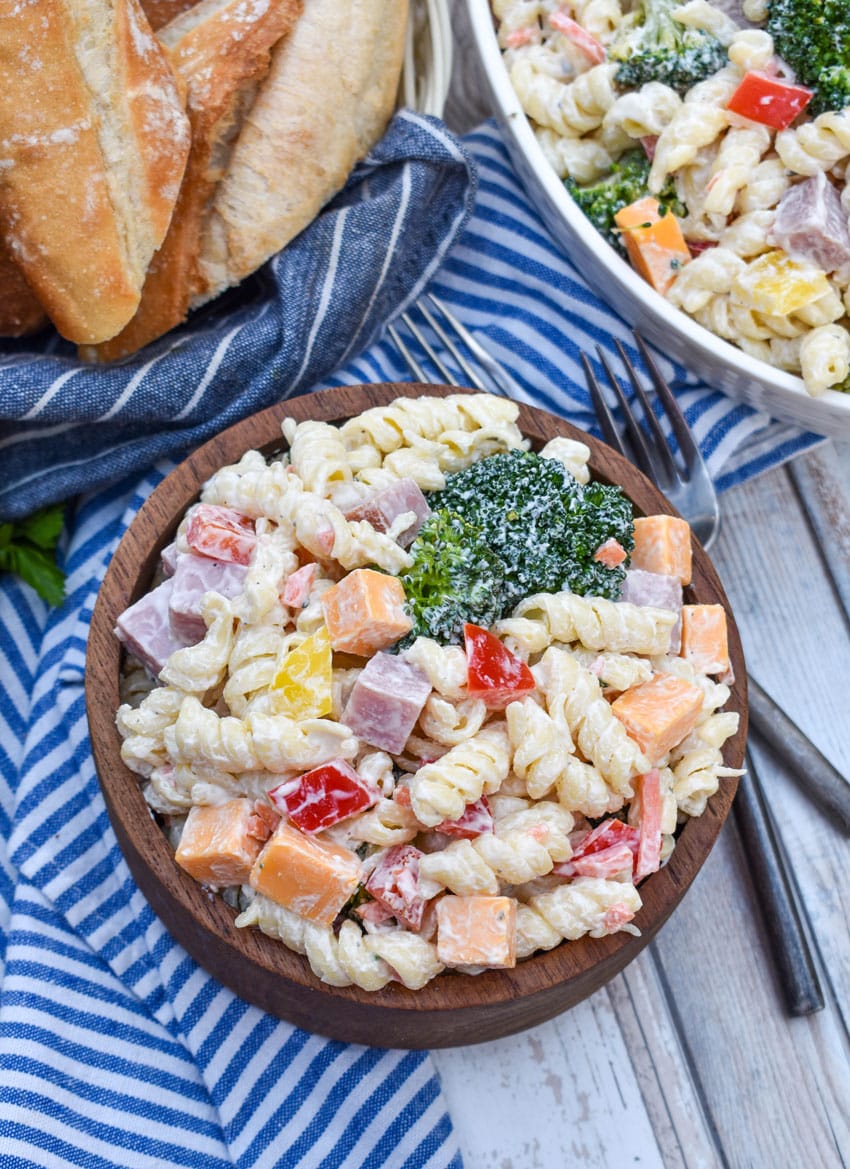 creamy ranch pasta salad in a small wooden bowl
