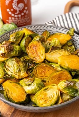 maple sriracha brussels sprouts in a gray bowl