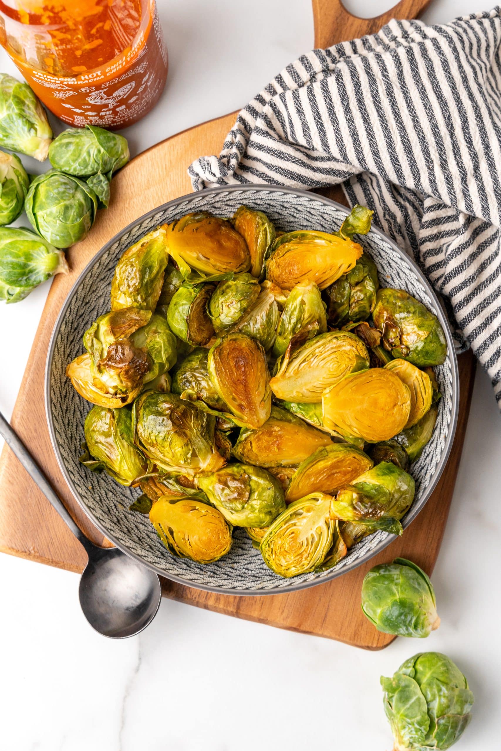 maple sriracha brussels sprouts in a gray bowl