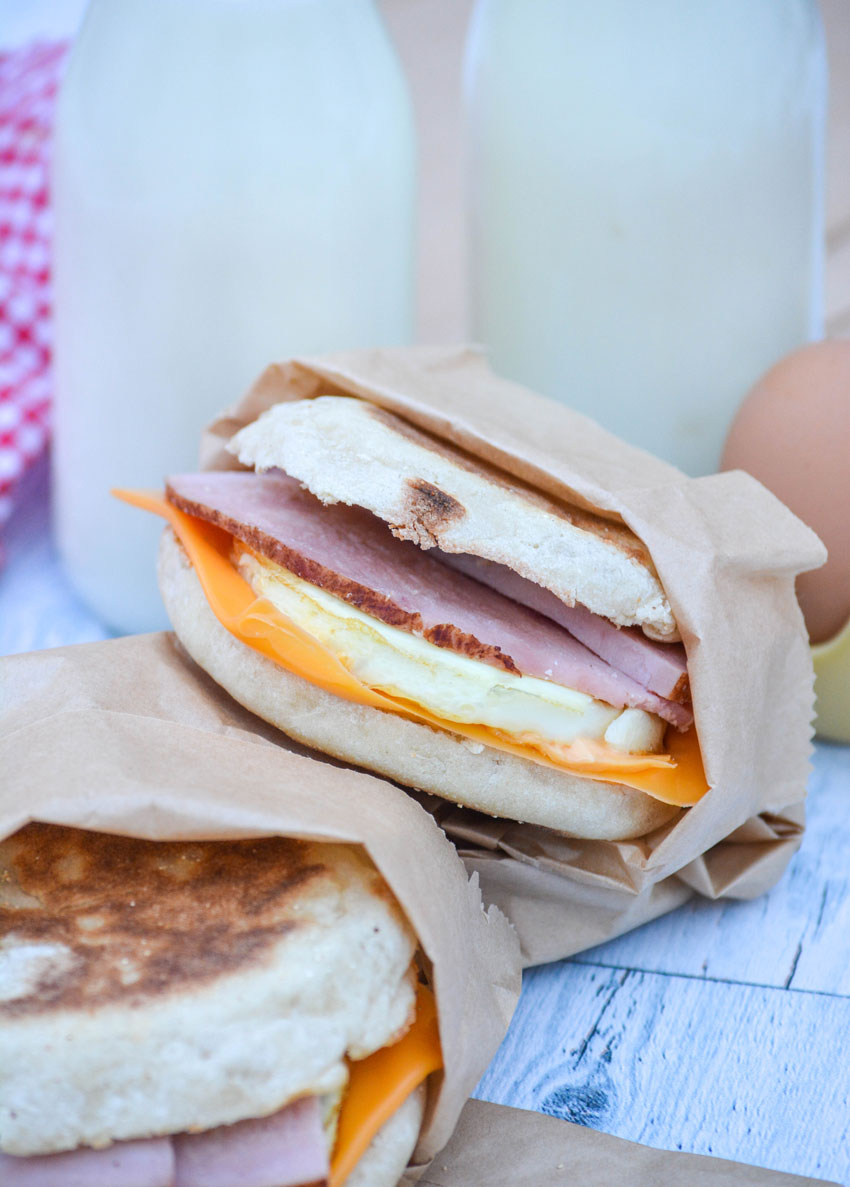 two freezer breakfast sandwiches wrapped in brown paper sandwich bags