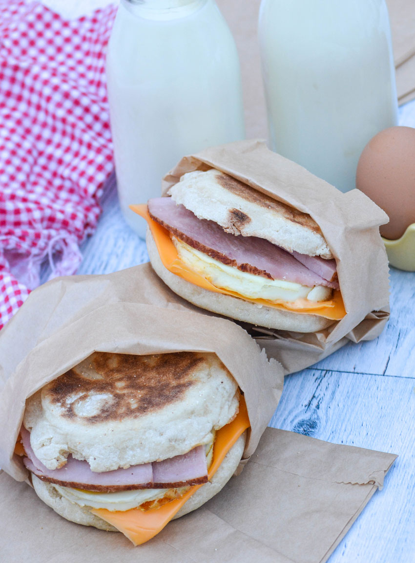 two freezer breakfast sandwiches wrapped in brown paper sandwich bags