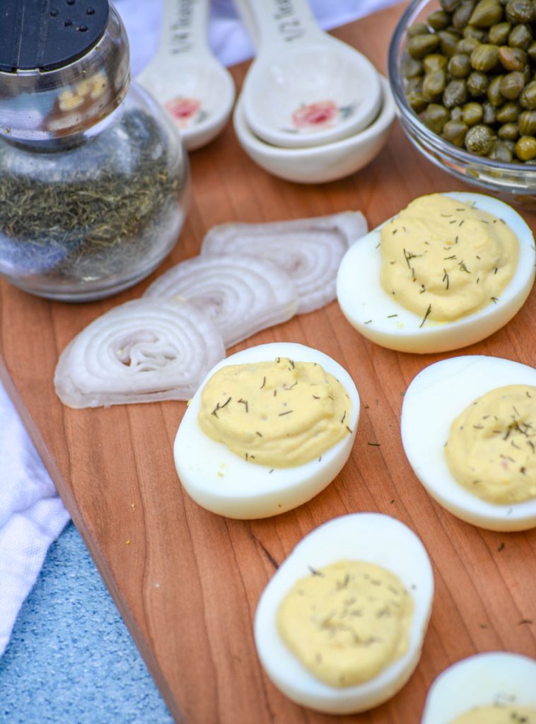 French-Style Deviled Eggs shown on a wooden cutting board