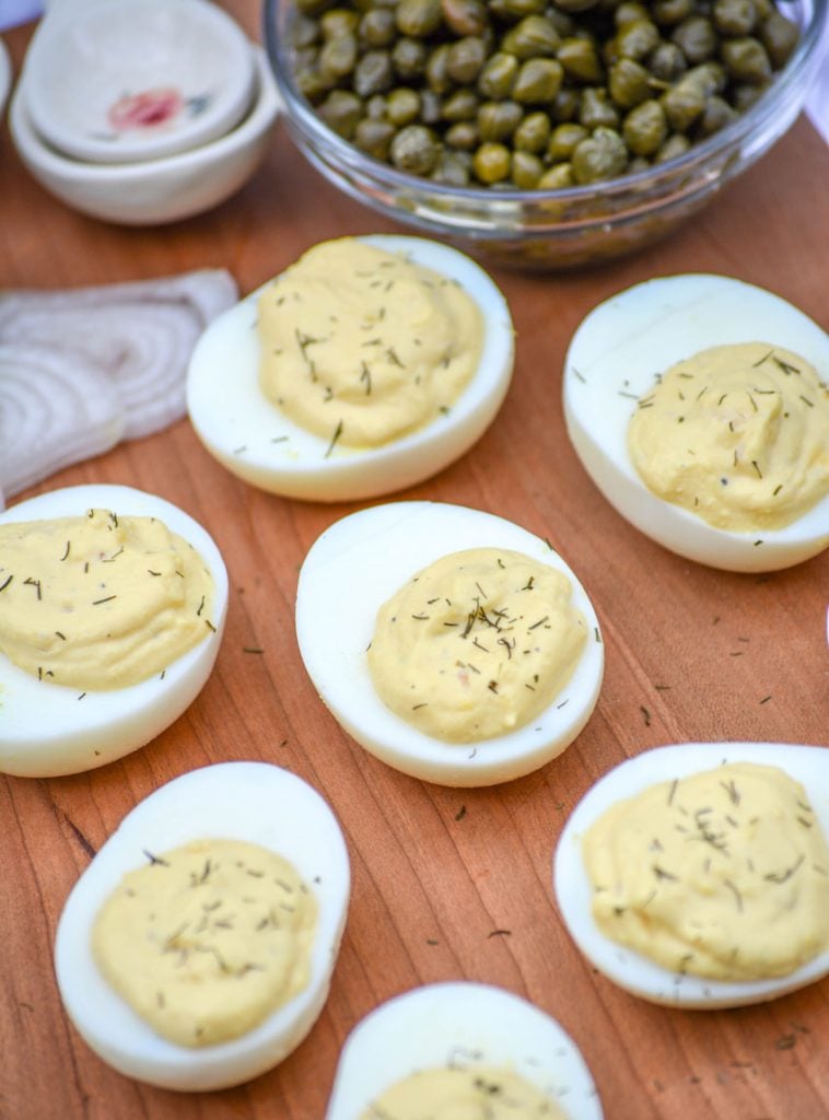 French-Style Deviled Eggs shown on a wooden cutting board
