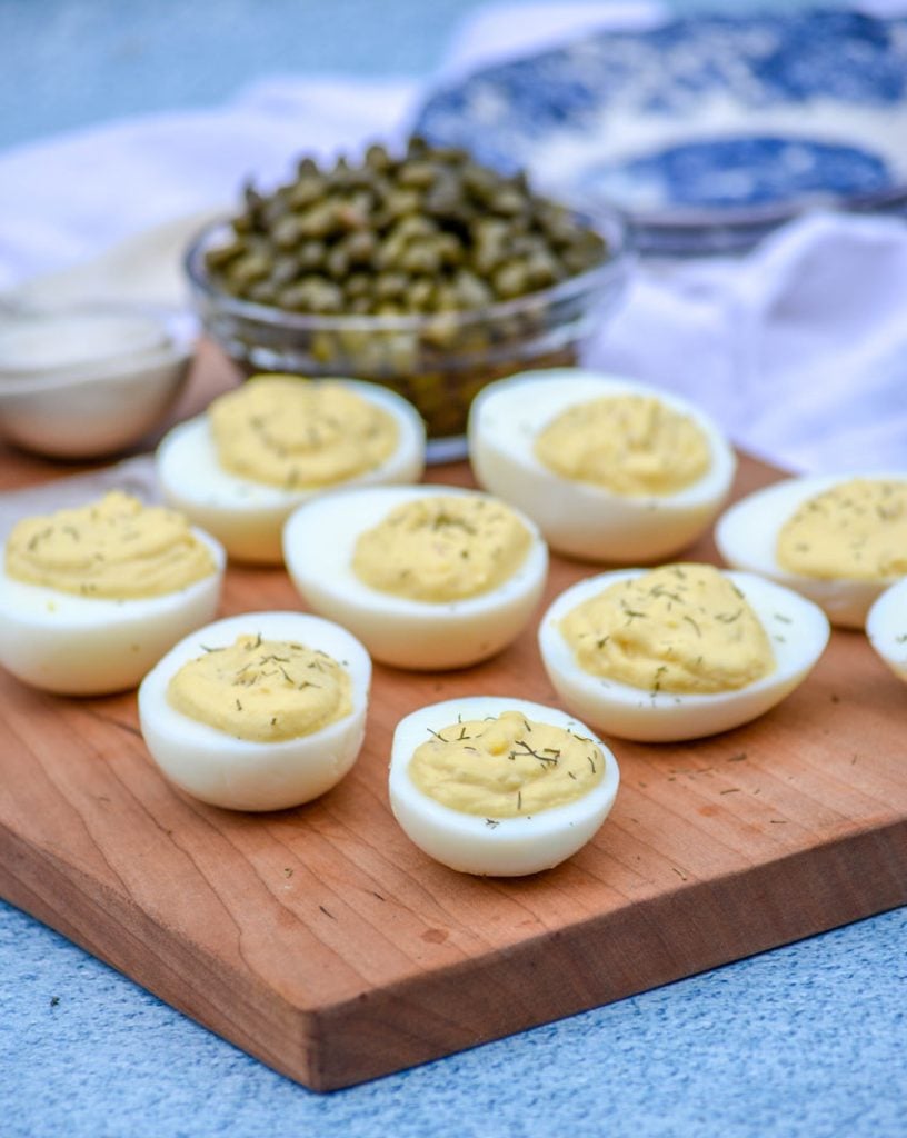 French-Style Deviled Eggs shown on a wooden cutting board