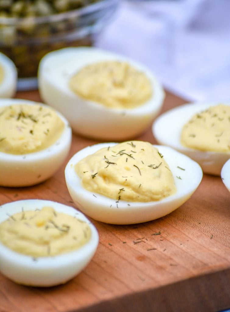 French-Style Deviled Eggs shown on a wooden cutting board