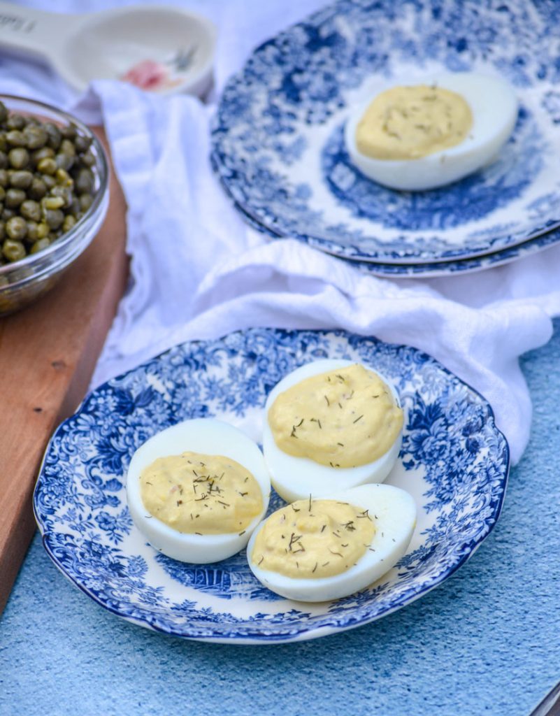 French-Style Deviled Eggs shown on blue and white tea plates