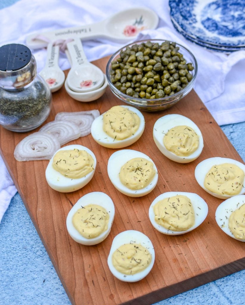 French-Style Deviled Eggs shown on a wooden cutting board