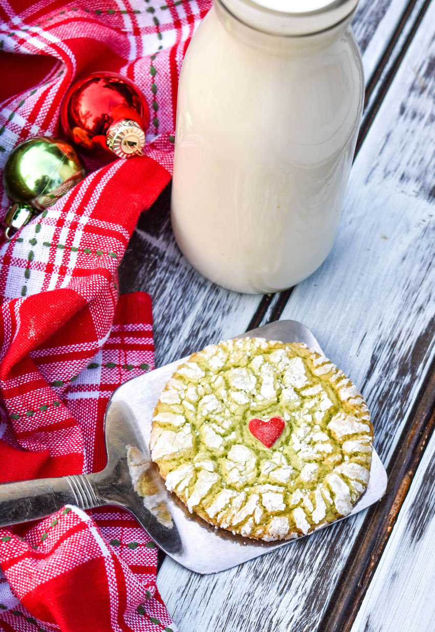 a grinch cookie on a silver spatula