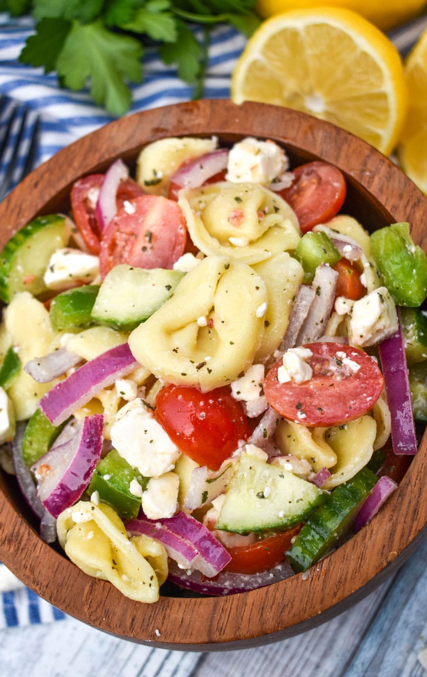 mediterranean tortellini pasta salad in a wooden bowl