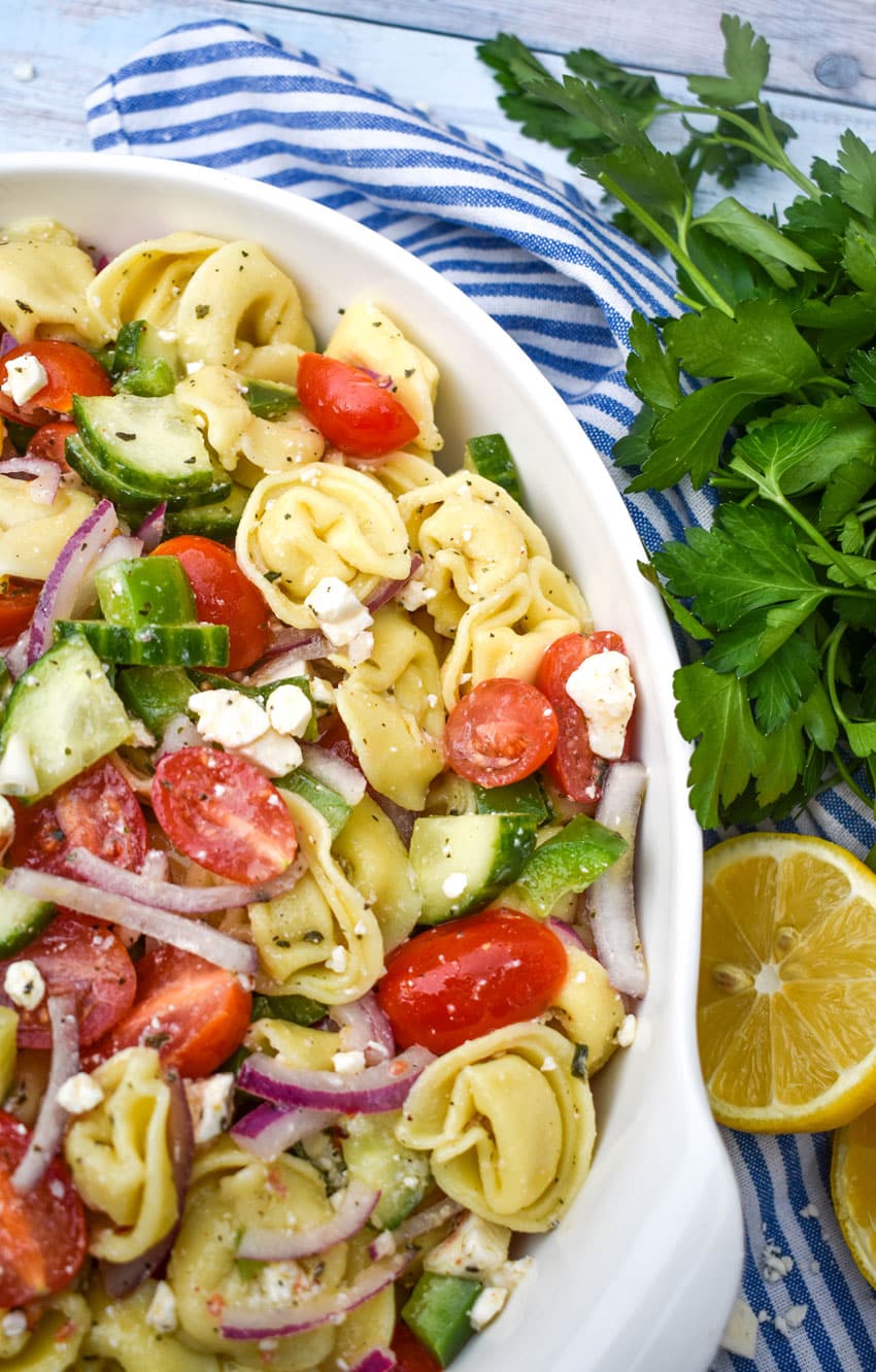 Mediterranean tortellini pasta salad on a white serving bowl 