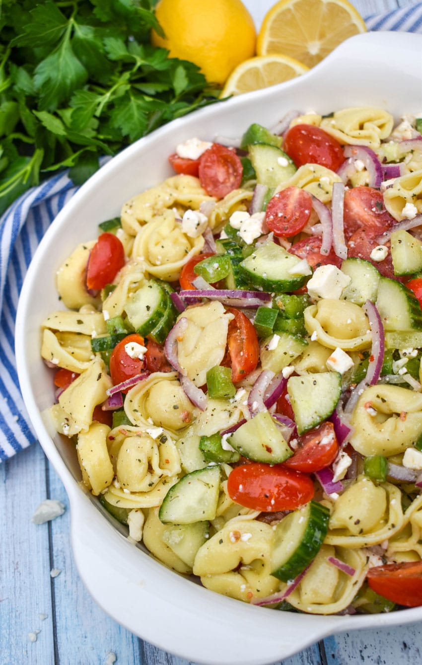 Mediterranean tortellini pasta salad on a white serving bowl 