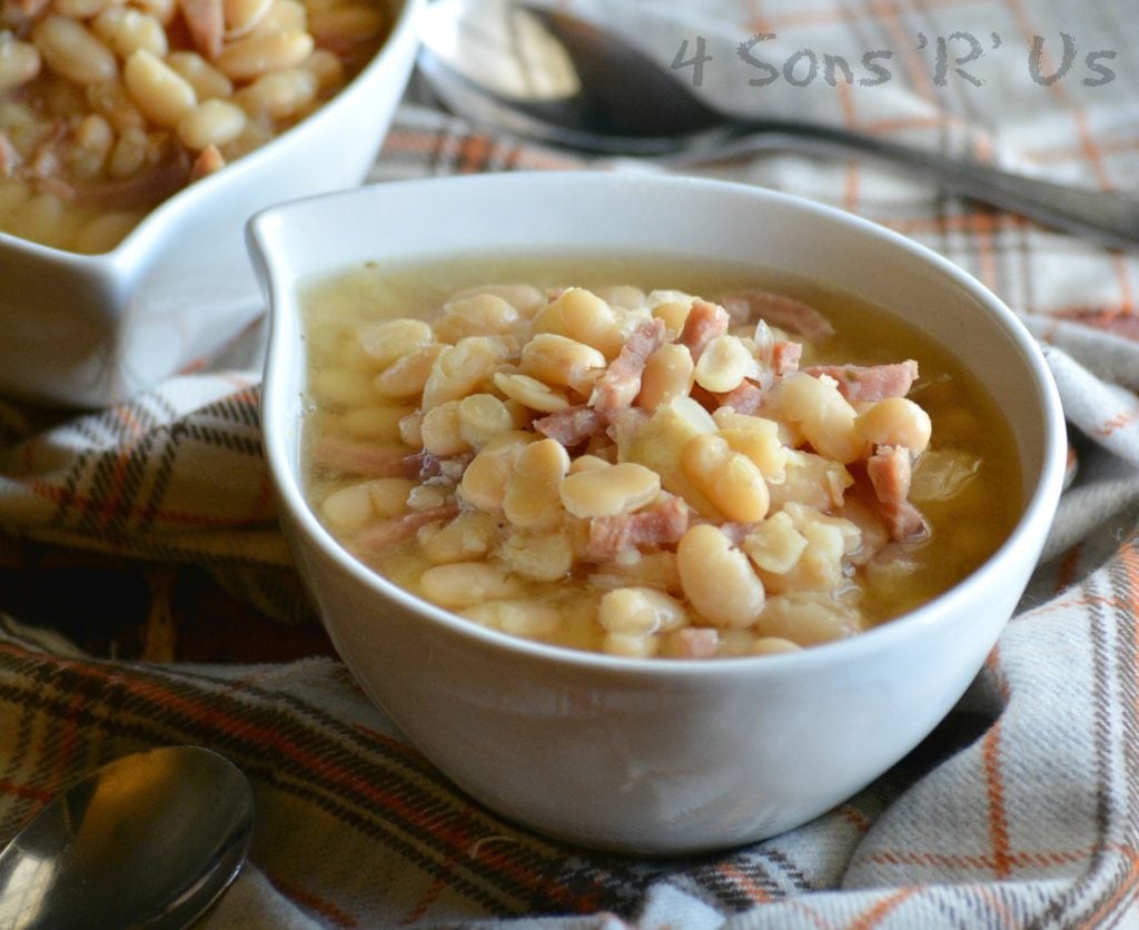 Crockpot ham & white bean soup shown served in white bowls on a flannel napkin