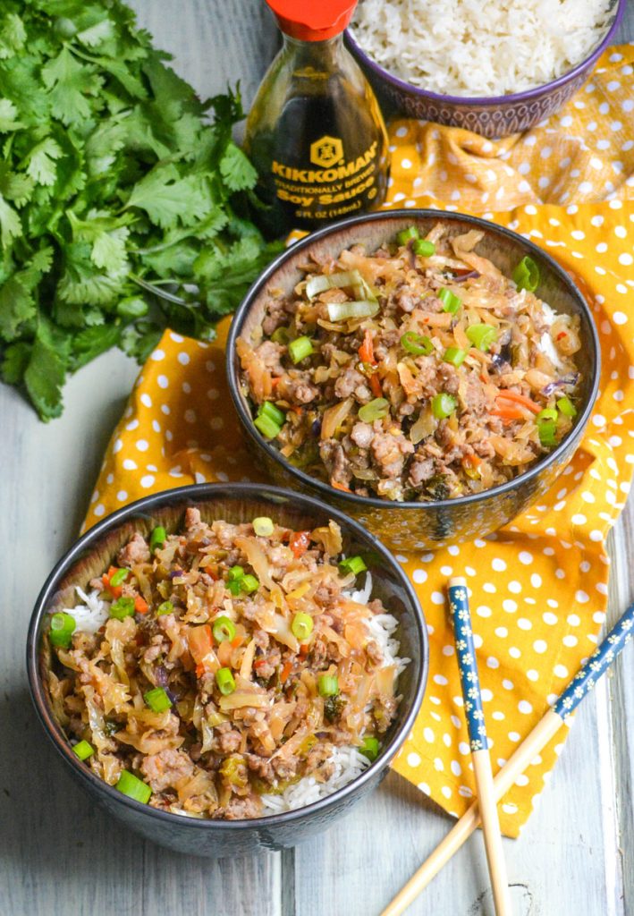 pork egg roll bowl shown with chop sticks 