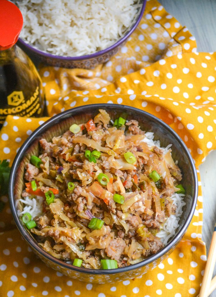 pork egg roll bowl shown with chop sticks 