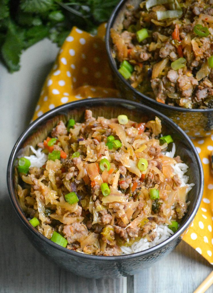 pork egg roll bowl shown with chop sticks 