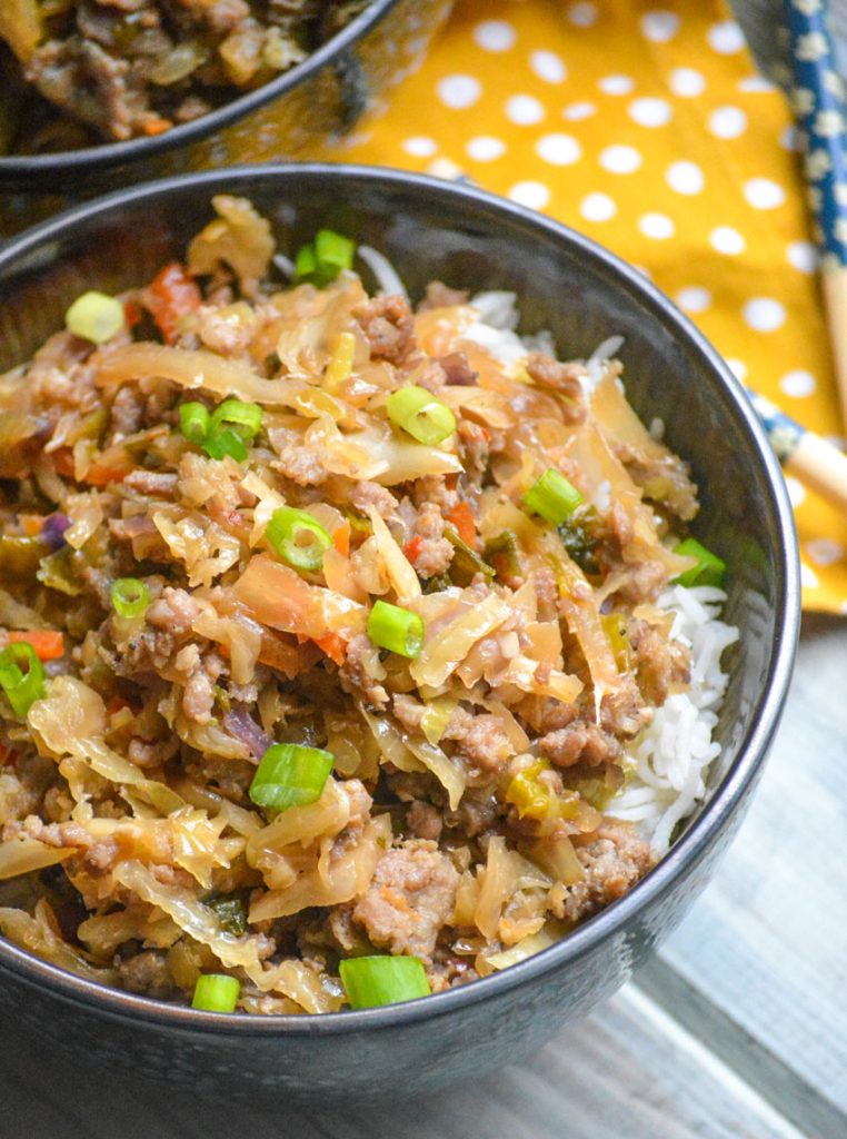 pork egg roll bowl shown with chop sticks 