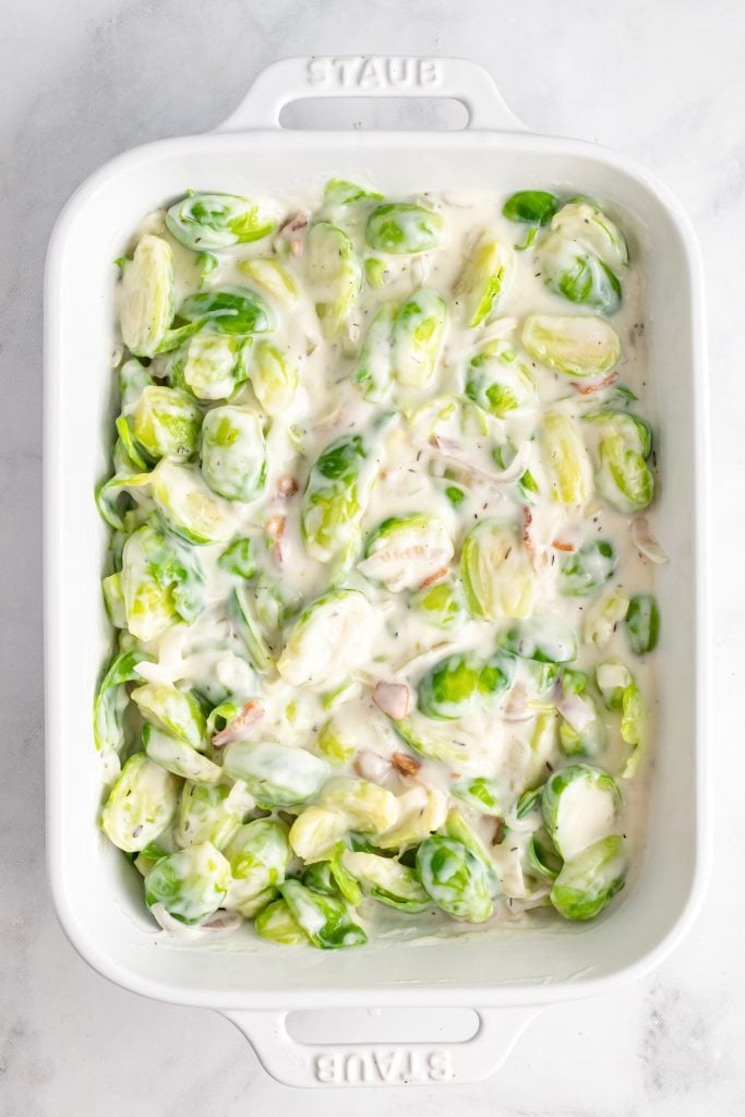 creamy burssels sprouts in a white casserole dish