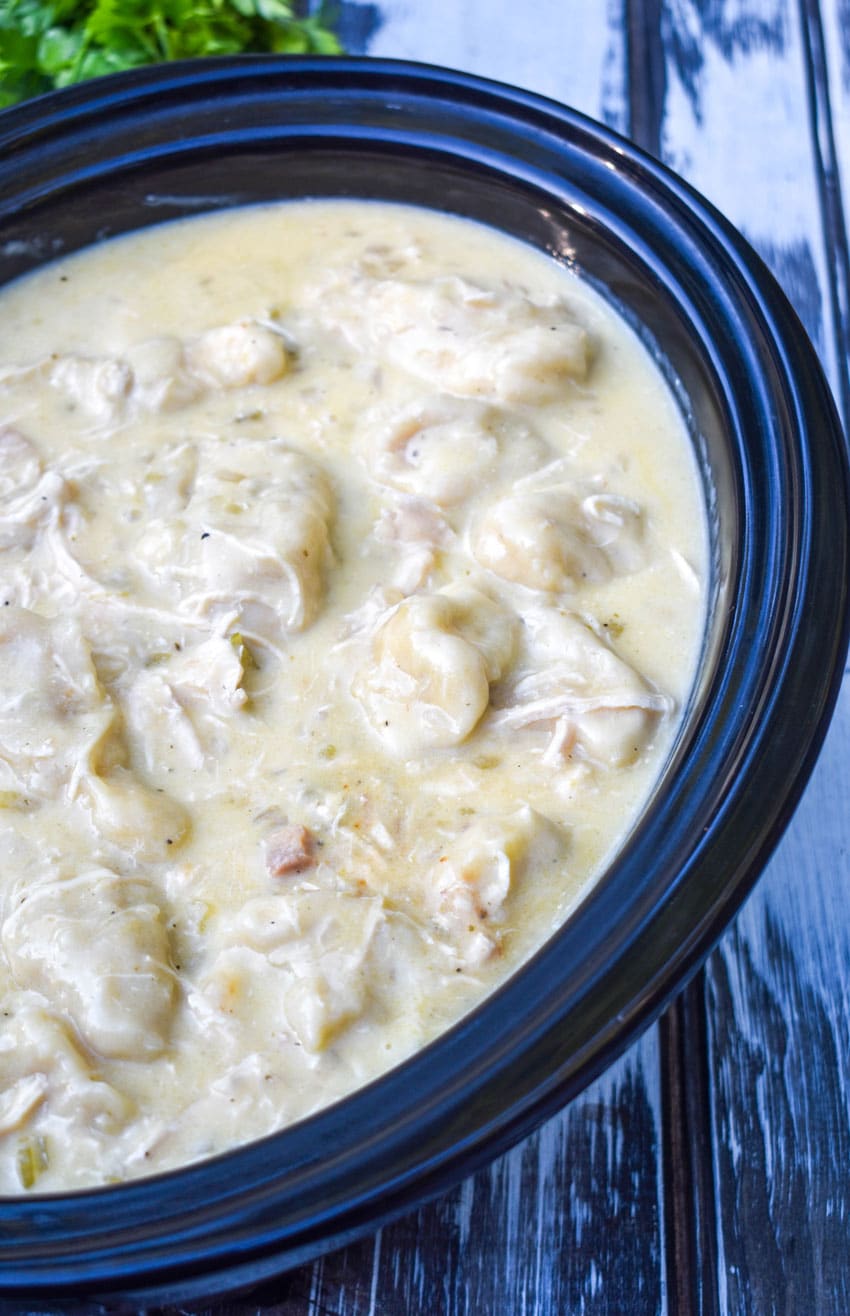 slow cooker chicken and dumplings in a black crock