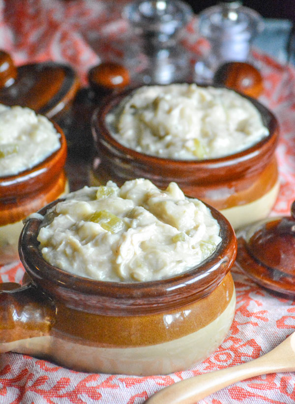 Slow Cooker Chicken & Dumplings shown served in three brown stoneware bowls