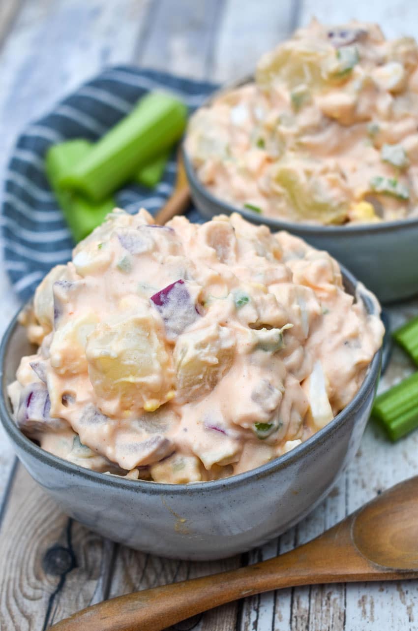 buffalo potato salad in two small gray bowls