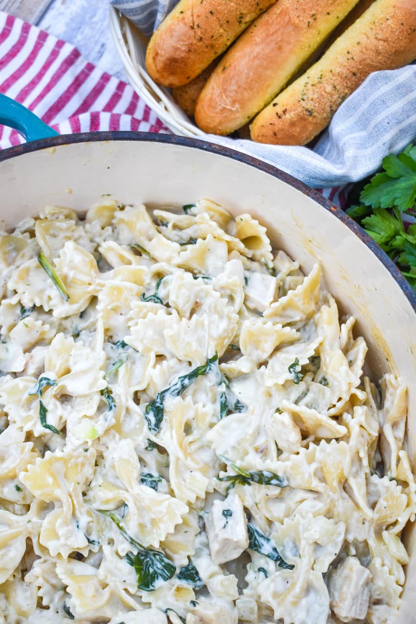 chicken florentine and farfalle pasta in a large pot