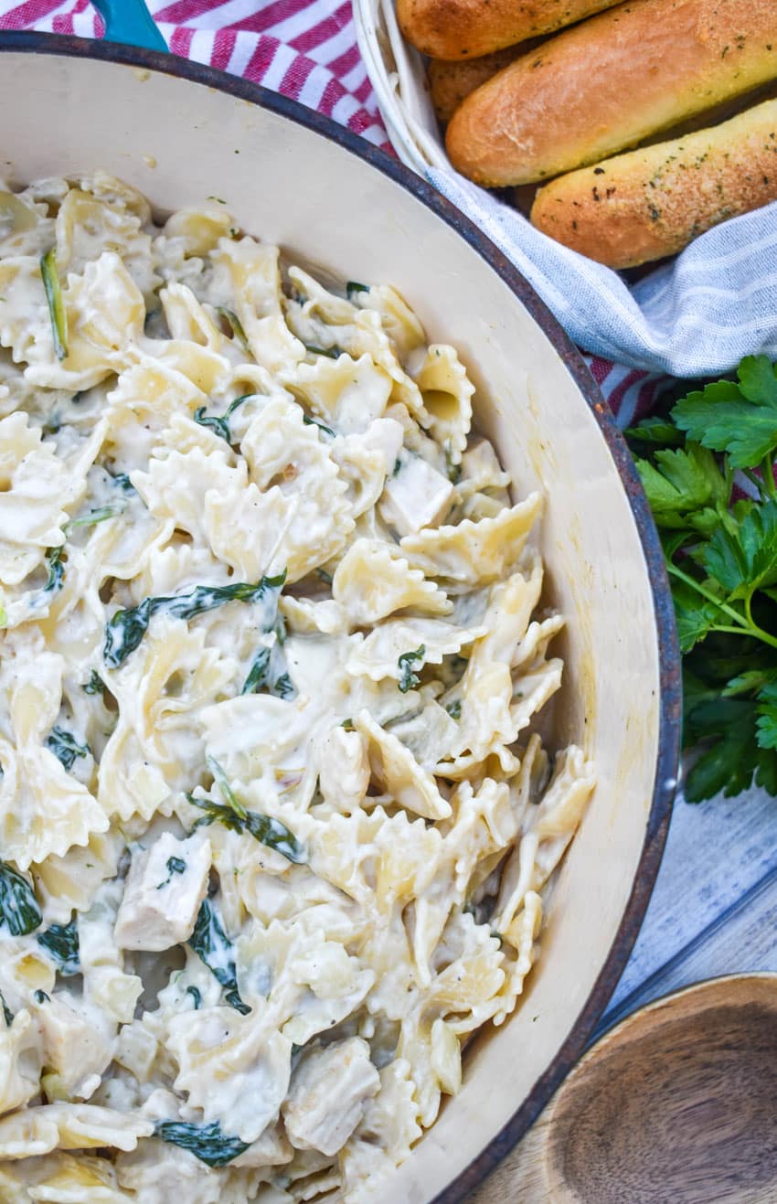 chicken florentine and farfalle pasta in a large pot