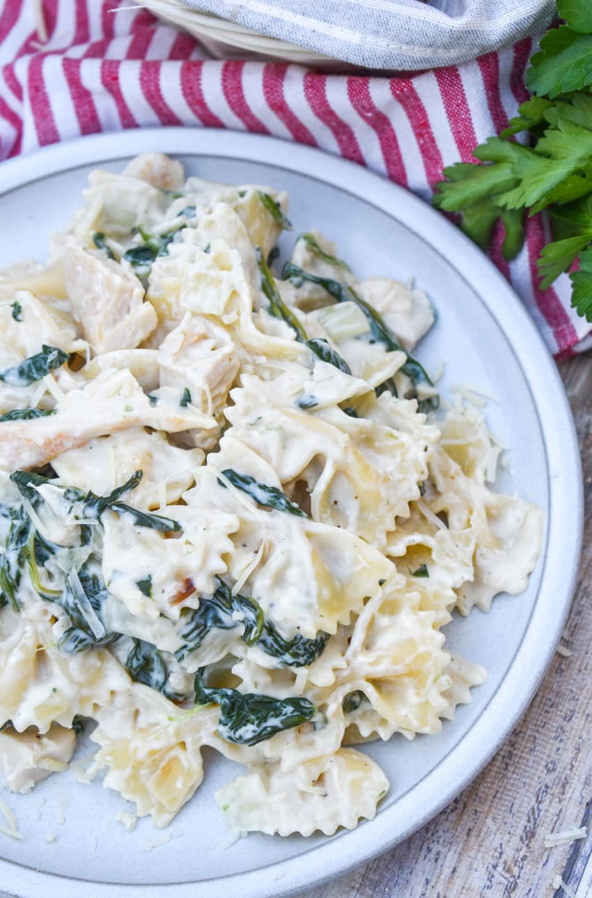 chicken florentine and farfalle paste on a white plate
