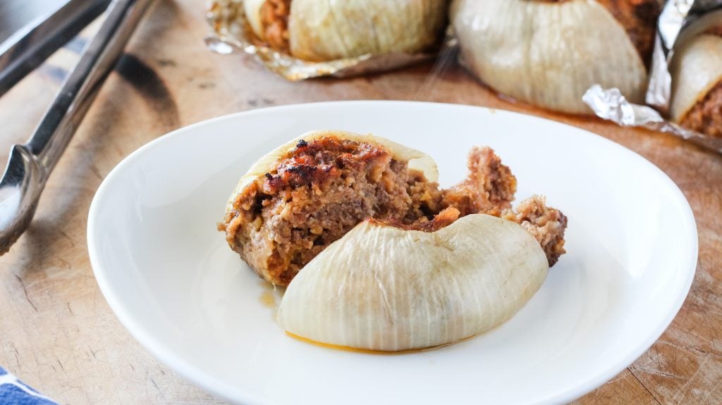 a grilled onion bomb served on a white plate