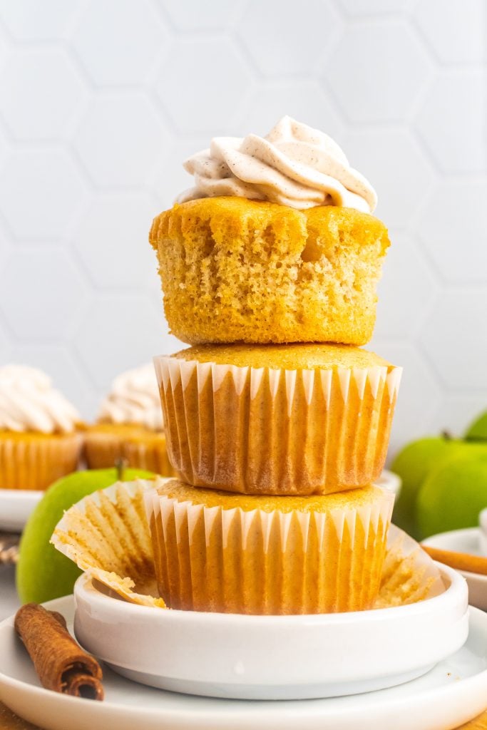 a stack of three apple pie cupcakes on a small white plate