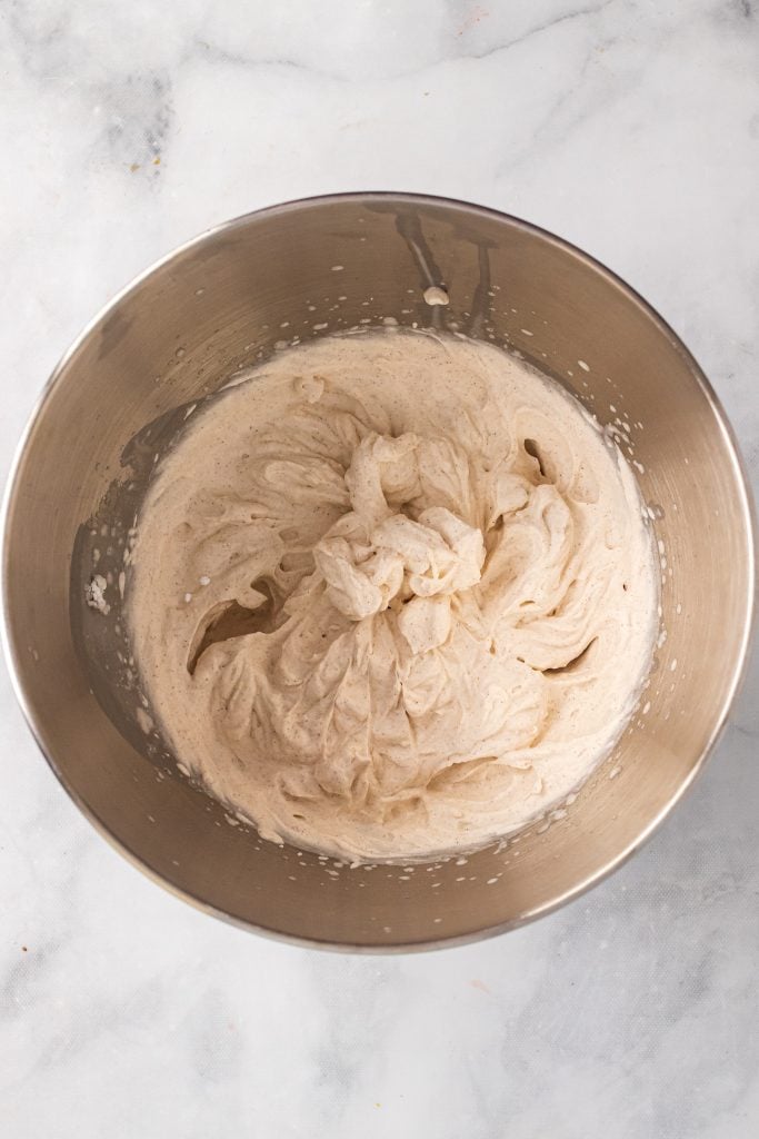 cinnamon whipped cream in stainless steel mixing bowl
