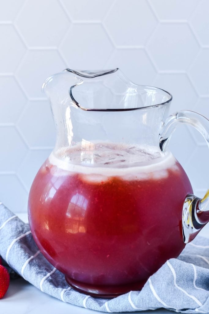 strawberry iced tea in a glass pitcher